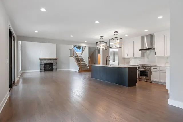 a large kitchen with stainless steel appliances granite countertop a large counter top and a stove