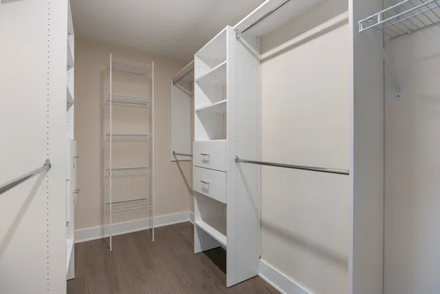 a view of walk in closet with empty racks