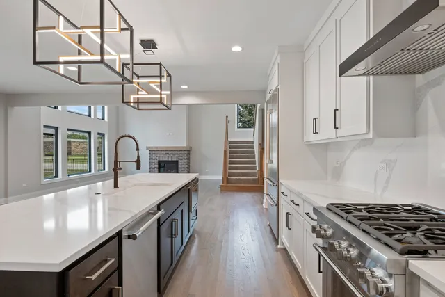 a kitchen with granite countertop a stove and a sink