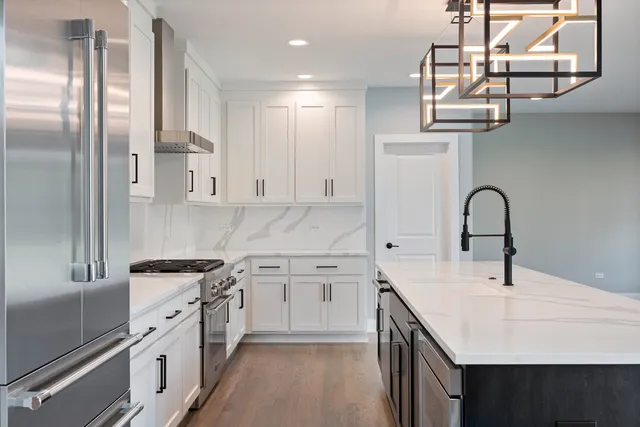 a kitchen with stainless steel appliances a sink a stove and a refrigerator