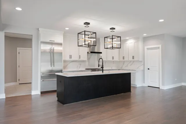 a large kitchen with stainless steel appliances granite countertop a sink and cabinets