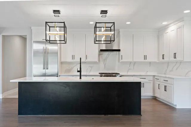 a kitchen with stainless steel appliances granite countertop a sink a counter space and cabinets