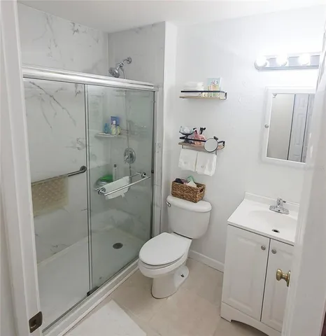 a bathroom with a toilet a sink and shower