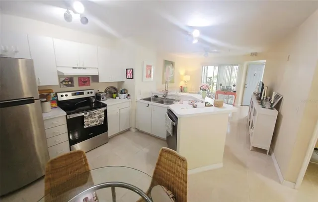 a kitchen with a sink appliances cabinets and a counter top space