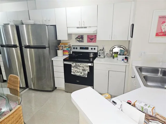 a kitchen with a refrigerator sink and stove