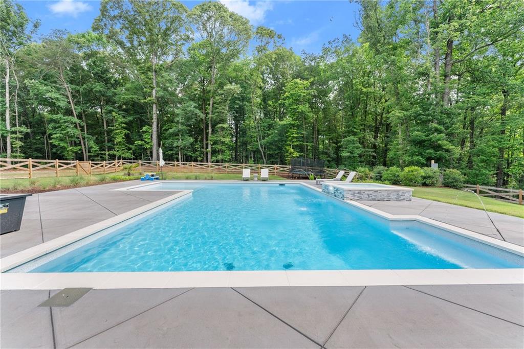 6998 Britt Gailey Road Clermont, GA 30527 - Photo 64 of 92 a view of a swimming pool with an outdoor space and seating area