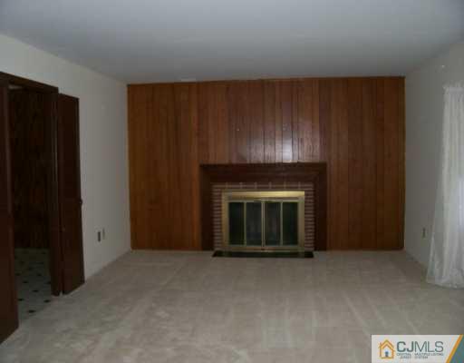 9 Flower Road Somerset, NJ 08873 - Photo 3 of 8 a view of an empty room with wooden floor and a cabinet