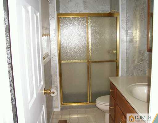 9 Flower Road Somerset, NJ 08873 - Photo 4 of 8 a bathroom with a shower and a toilet