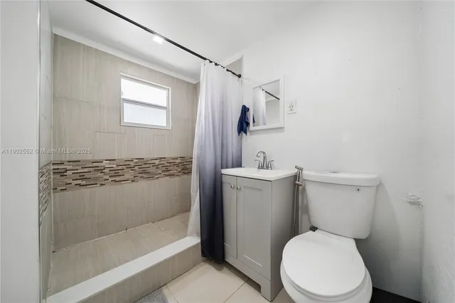 a white toilet sitting next to a bathroom sink