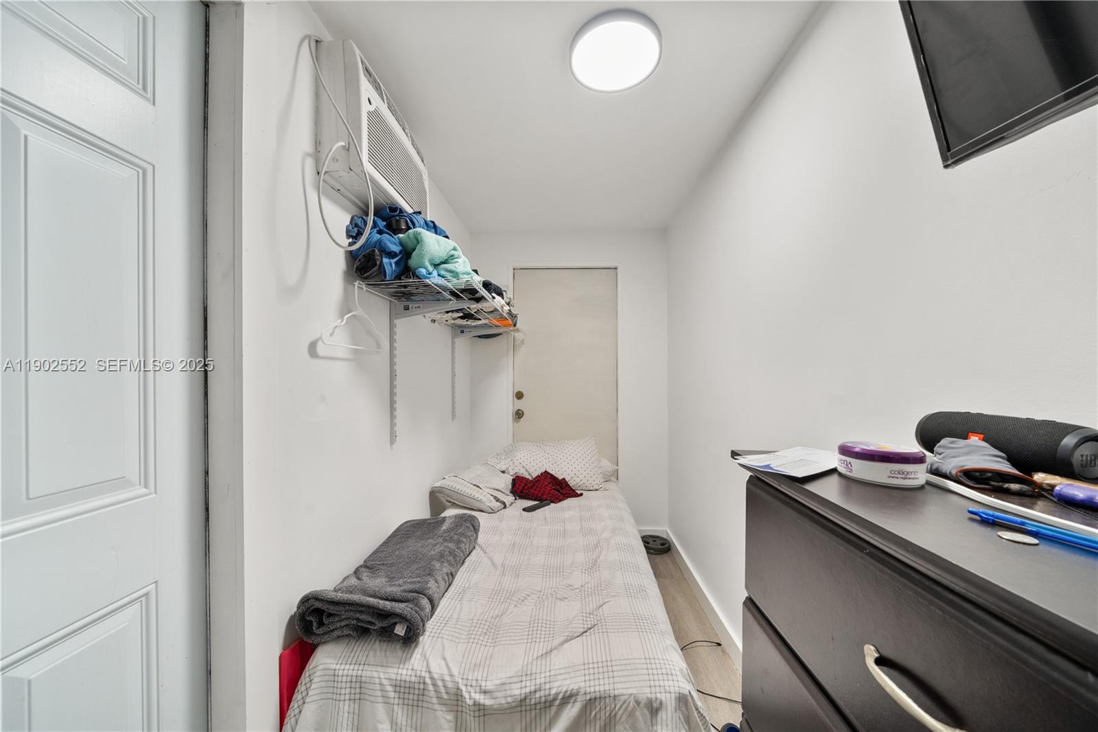 1257 Northwest 58th Street Miami, FL 33142 - Photo 16 of 27 a bed room with a bed and a potted plant