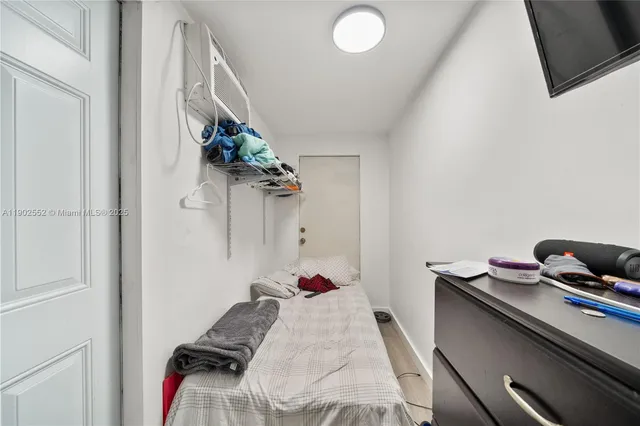 a bed room with a bed and a potted plant