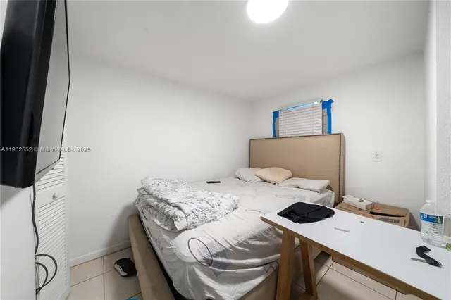 a bedroom with a bed and a table