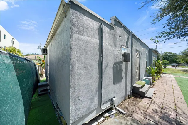 a view of a two chairs in back yard of the house