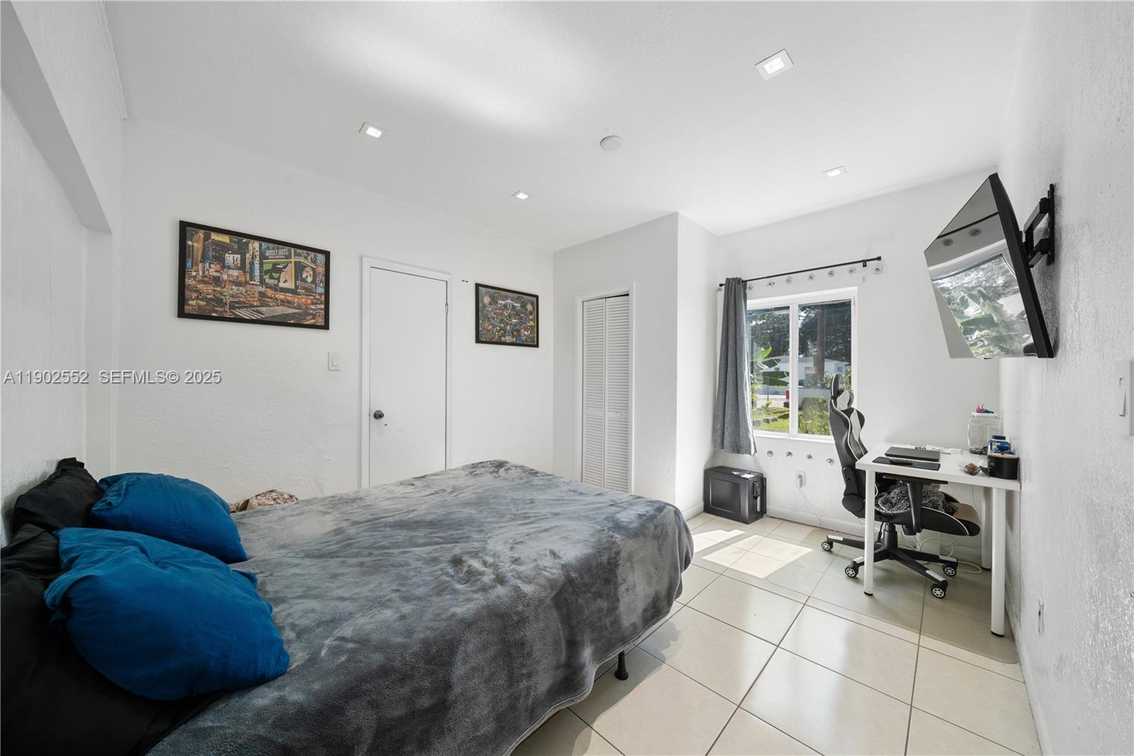 1257 Northwest 58th Street Miami, FL 33142 - Photo 26 of 27 a bed room with a bed and a chair