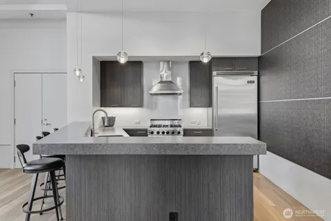 a kitchen with stainless steel appliances granite countertop a sink and cabinets