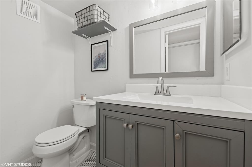 2011 Northeast 32nd Court, Unit 26 Lighthouse Point, FL 33064 - Photo 11 of 13 a bathroom with a toilet a sink and mirror