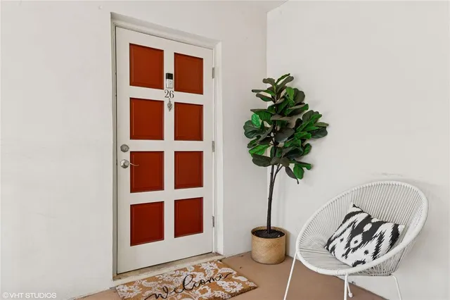 a vase of flowers sitting on a table with a potted plant