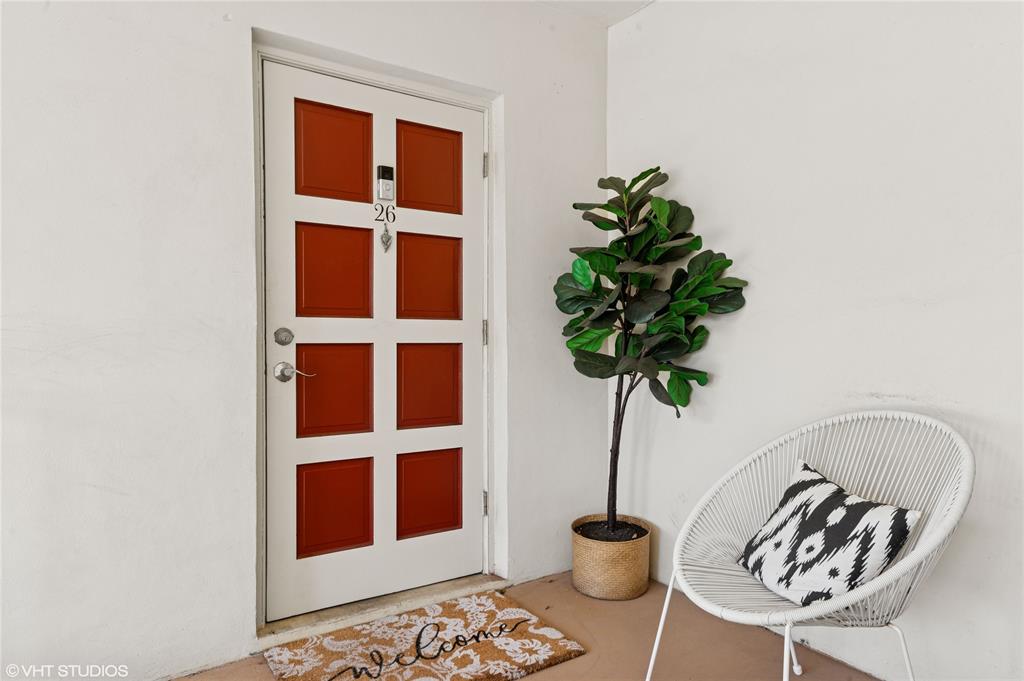 2011 Northeast 32nd Court, Unit 26 Lighthouse Point, FL 33064 - Photo 3 of 13 a vase of flowers sitting on a table with a potted plant
