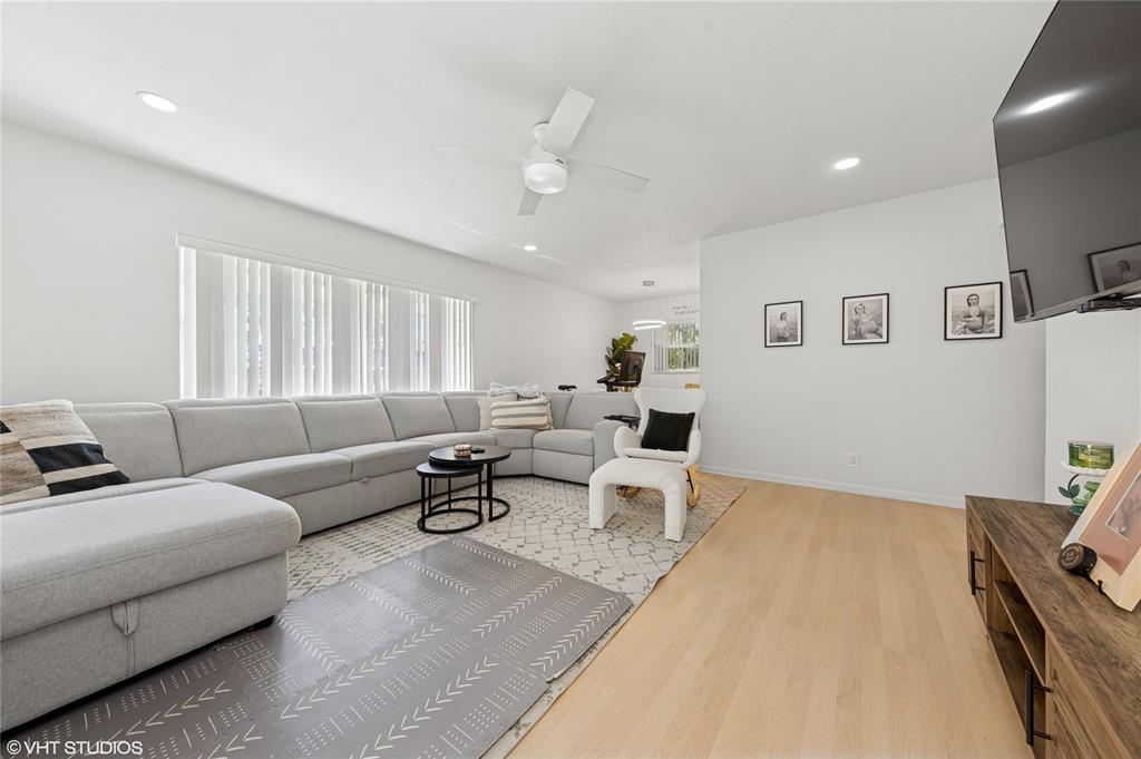 2011 Northeast 32nd Court, Unit 26 Lighthouse Point, FL 33064 - Photo 5 of 13 a living room with furniture and wooden floor