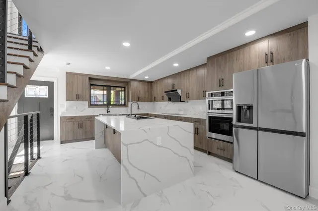 a large kitchen with cabinets and stainless steel appliances
