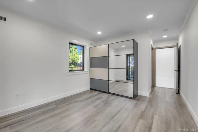 a view of a room with wooden floor and window