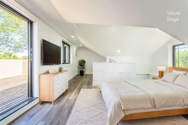 a spacious bedroom with a large bed and a flat screen tv