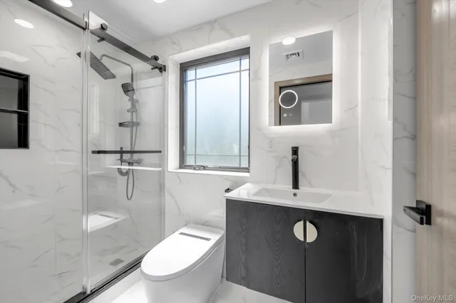 a bathroom with a toilet sink and shower