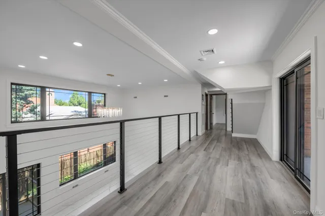 a view of hallway with wooden floor