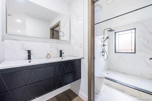 a bathroom with a tub sink and mirror