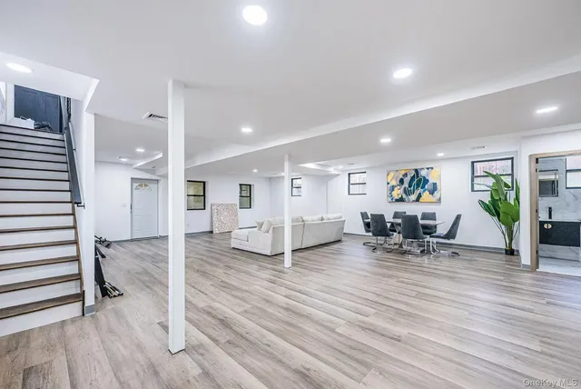 a view of a livingroom with wooden floor and furniture