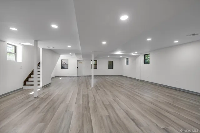 a view of a room with wooden floors and stairs