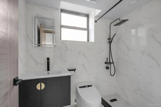 a bathroom with a sink a toilet and a window