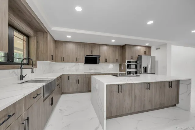 a kitchen with stainless steel appliances a sink stove and cabinets