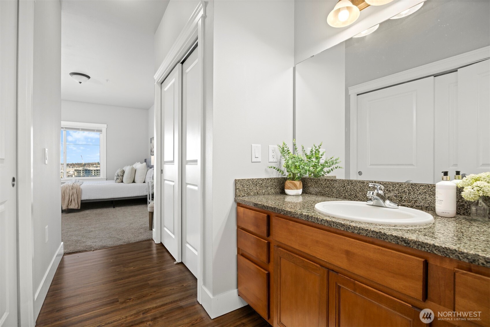 1015 Railroad Avenue, Unit 418 Bellingham, WA 98225 - Photo 14 of 23 a en suite bathroom with a granite countertop sink and a mirror