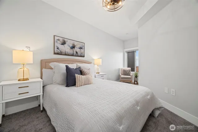 a bedroom with bed and painting on the wall