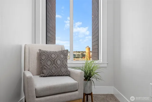 a white couch sitting in a bedroom next to a window