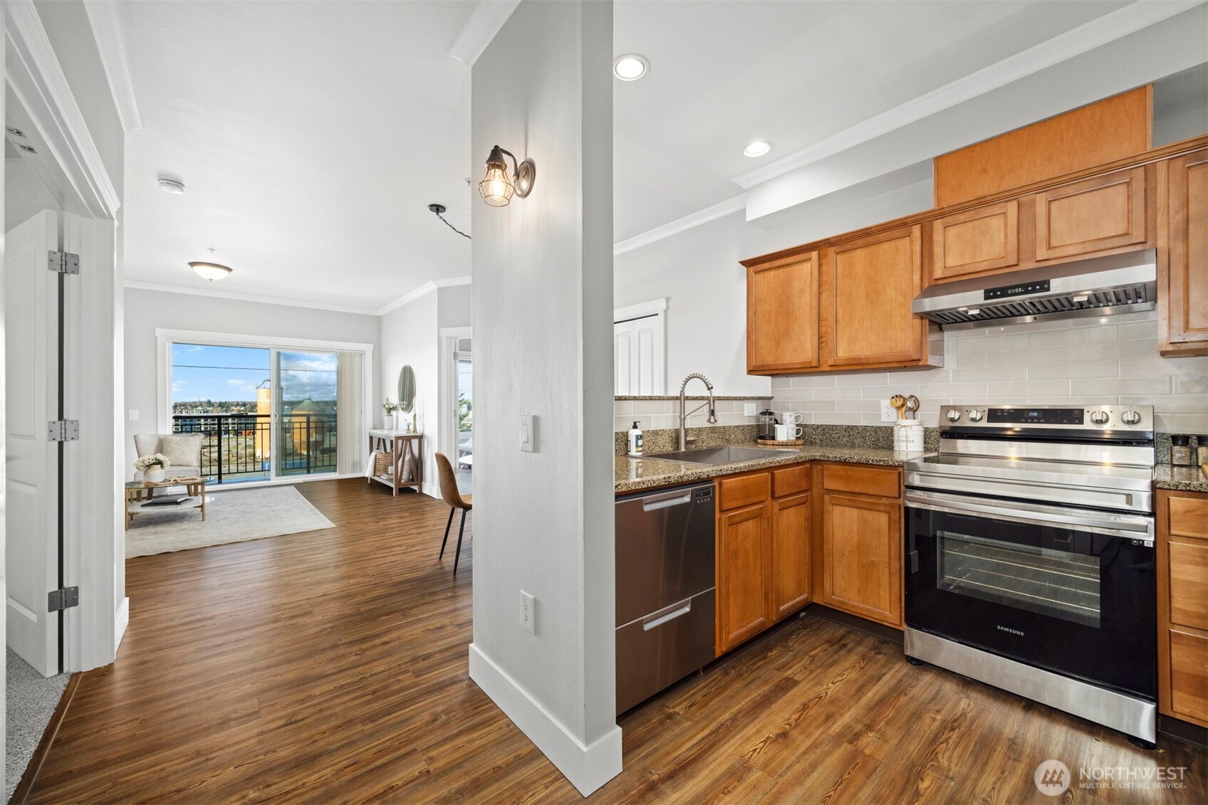 1015 Railroad Avenue, Unit 418 Bellingham, WA 98225 - Photo 5 of 23 a kitchen with stainless steel appliances granite countertop a stove and a refrigerator