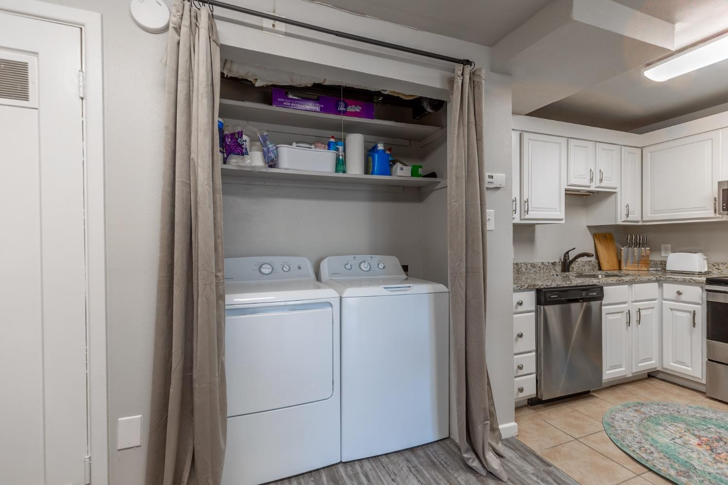 2124 Broadway Street Lubbock, TX 79401 - Photo 14 of 14 a view of cabinets a washer and dryer