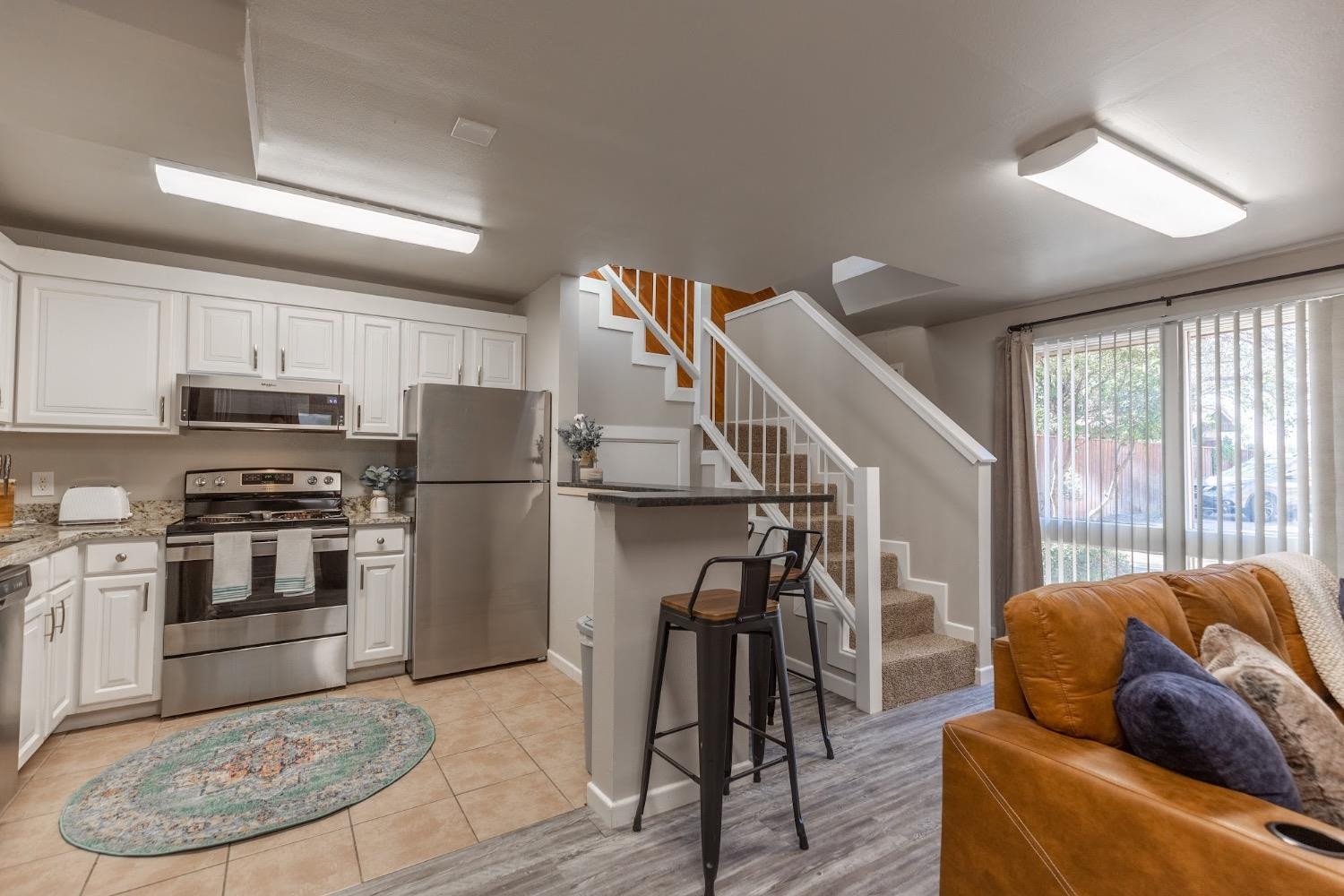 2124 Broadway Street Lubbock, TX 79401 - Photo 7 of 14 a living room with stainless steel appliances furniture and a kitchen view