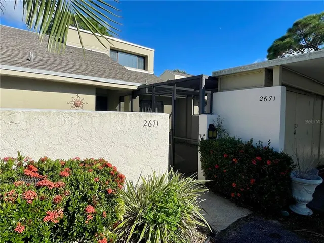 a view of a house with a flower garden