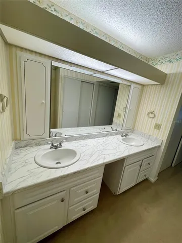 an empty room with a ceiling fan and a window