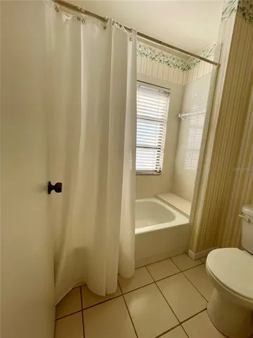 an empty room with a empty space and windows