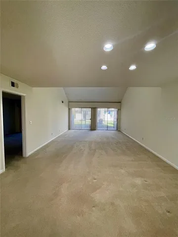 a kitchen with granite countertop white cabinets stainless steel appliances and a sink