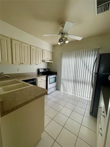 a kitchen with stainless steel appliances granite countertop a sink and cabinets