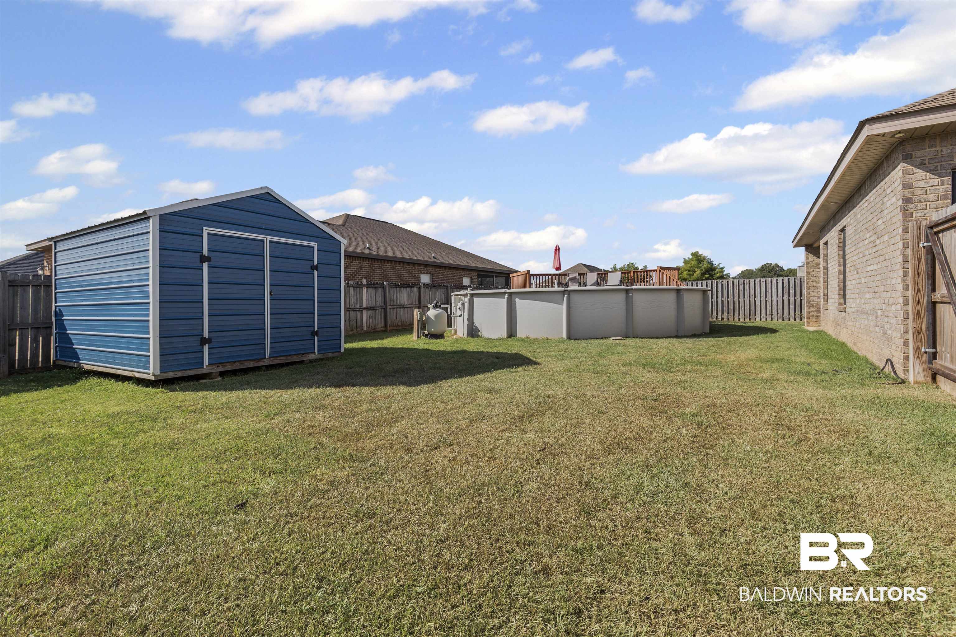 4107 Nottingham Drive Semmes, AL 36575 - Photo 21 of 23 Fenced backyard with an outdoor pool and a storage shed