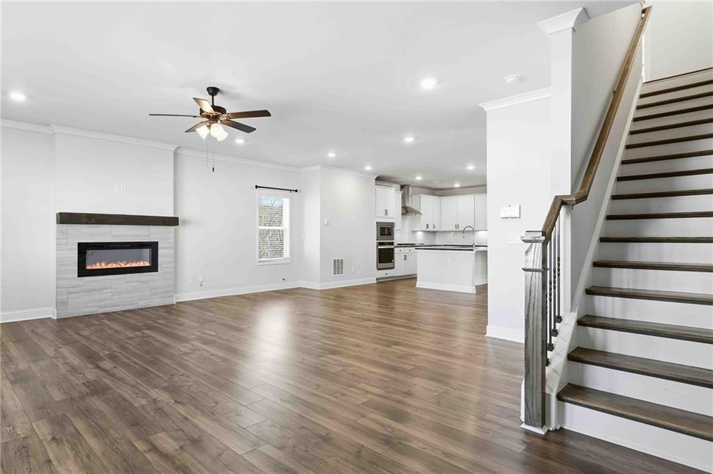 3302 Monarch Avenue Duluth, GA 30096 - Photo 21 of 83 a view of a kitchen with wooden floor and a ceiling fan