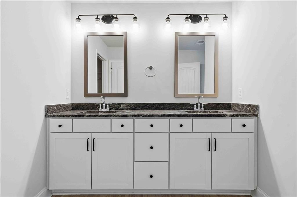 3302 Monarch Avenue Duluth, GA 30096 - Photo 27 of 83 a bathroom with mirror sink and vanity