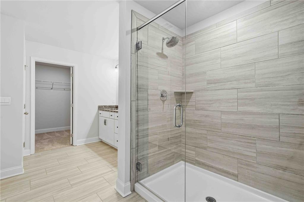 3302 Monarch Avenue Duluth, GA 30096 - Photo 29 of 83 a bathroom with a bathtub and a shower