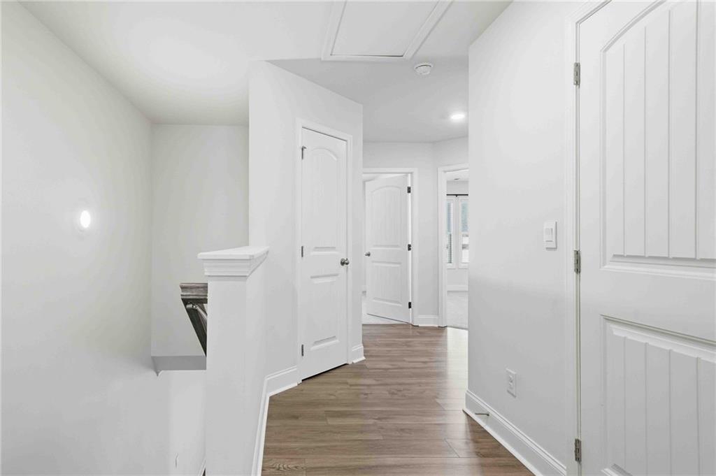 3302 Monarch Avenue Duluth, GA 30096 - Photo 39 of 83 a view of a hallway with wooden floor and staircase