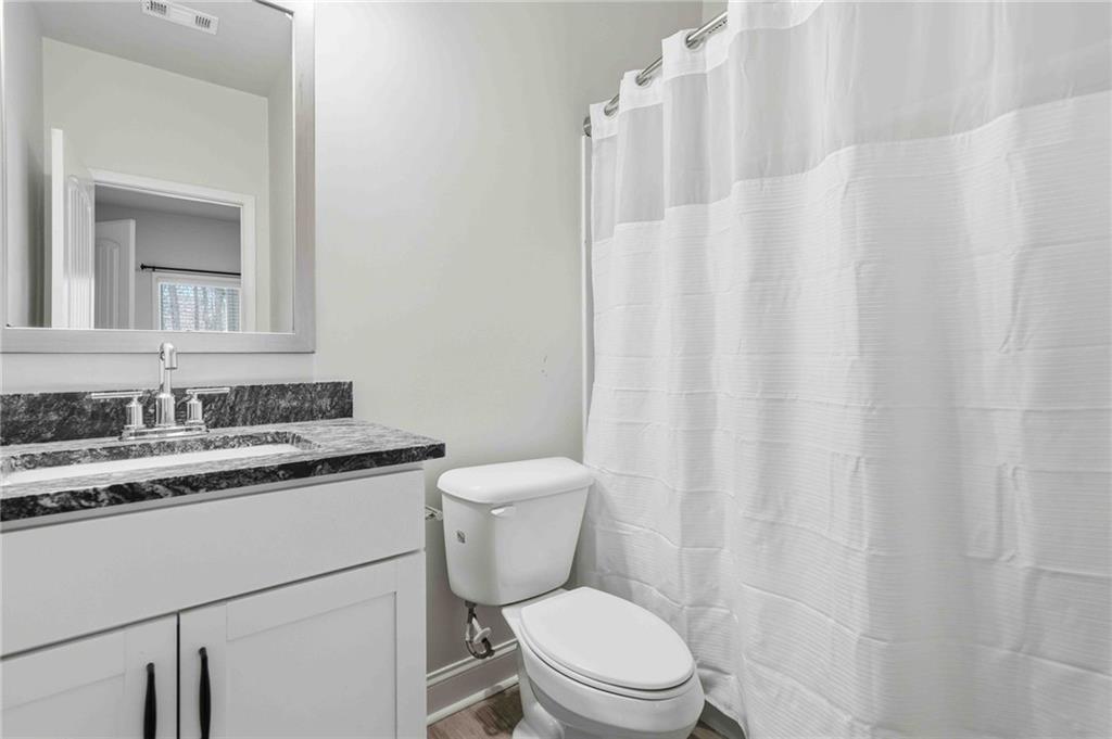 3302 Monarch Avenue Duluth, GA 30096 - Photo 51 of 83 a bathroom with a granite countertop sink mirror vanity and toilet